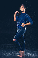 Image showing Young beautiful woman under splash of rain