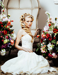 Image showing beauty young blond woman bride alone in luxury vintage interior with a lot of flowers