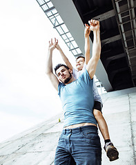 Image showing mature father with his son under the bridge having fun together happy family, lifestyle people concept 