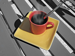 Image showing steaming coffee cup on a chair