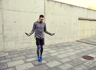 Image showing man exercising with jump-rope outdoors