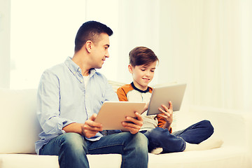 Image showing happy father and son with tablet pc at home