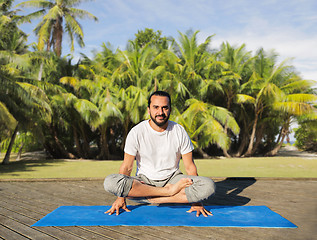 Image showing man making yoga in scale pose outdoors