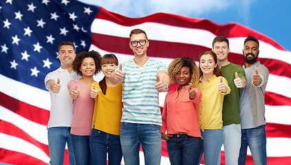 Image showing happy people showing thumbs up over american flag