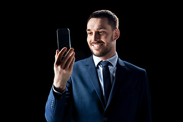 Image showing businessman with transparent smartphone