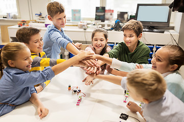 Image showing happy children holding hands at robotics school