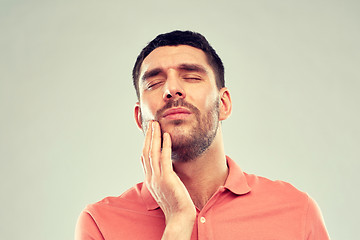 Image showing unhappy man suffering from toothache