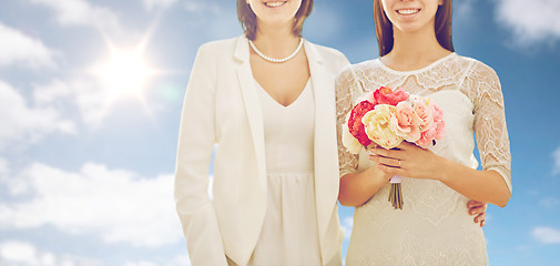 Image showing close up of happy lesbian couple with flowers