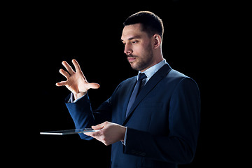 Image showing businessman in suit with transparent tablet pc