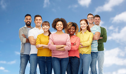 Image showing international group of happy people over blue sky