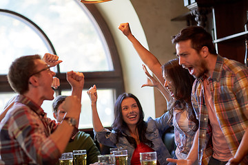 Image showing football fans or friends with beer at sport bar