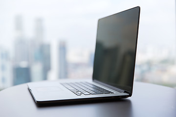 Image showing laptop computer with black screen on office table