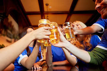 Image showing football fans clinking beer glasses at sport bar