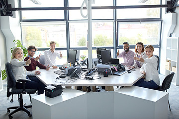 Image showing business team showing thumbs up at office