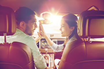 Image showing happy man and woman driving in car