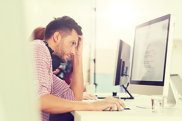 Image showing stressed software developer at office
