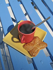 Image showing steaming coffee cup on a chair