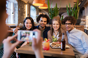 Image showing friends with smartphone photographing at cafe