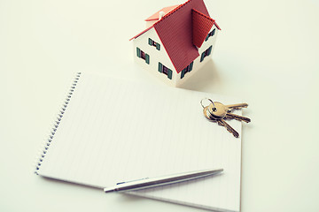 Image showing close up of home model, house keys and notebook