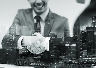 Image showing two businessmen shaking hands at office