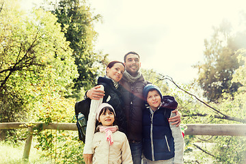 Image showing happy family with backpacks hiking