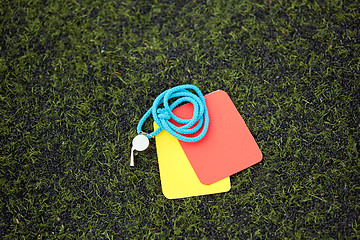 Image showing referee whistle and caution cards on soccer field