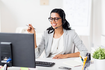 Image showing businesswoman with headset and computer at office