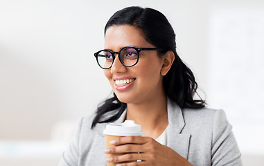 Image showing businesswoman with coffee in paper cup at office