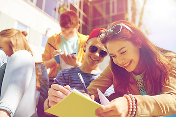 Image showing group of students with notebooks at school yard