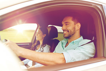 Image showing happy man and woman driving in car