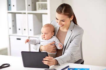 Image showing businesswoman with baby and tablet pc at office