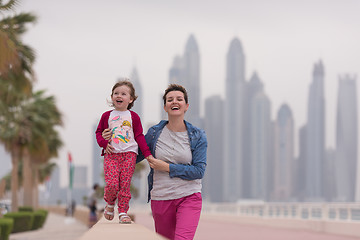 Image showing mother and cute little girl on the promenade