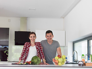 Image showing Young handsome couple in the kitchen