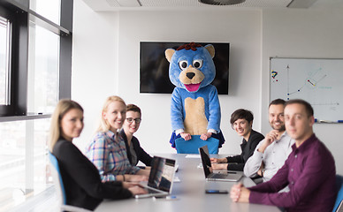 Image showing boss dresed as bear having fun with business people in trendy of