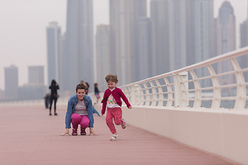 Image showing mother and cute little girl on the promenade