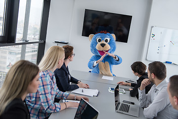 Image showing boss dresed as bear having fun with business people in trendy of