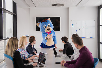 Image showing boss dresed as bear having fun with business people in trendy of