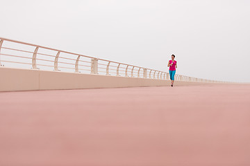 Image showing woman busy running on the promenade