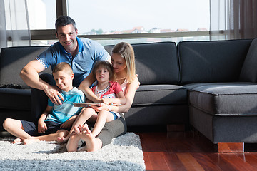 Image showing happy young couple spending time with kids