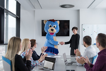 Image showing boss dresed as bear having fun with business people in trendy of