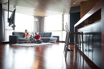 Image showing Happy family playing a video game