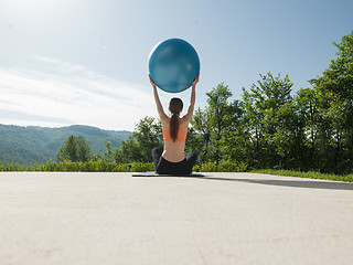 Image showing woman doing exercise with pilates ball