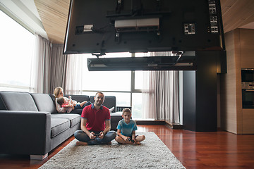 Image showing Happy family playing a video game