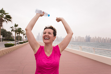 Image showing young woman celebrating a successful training run