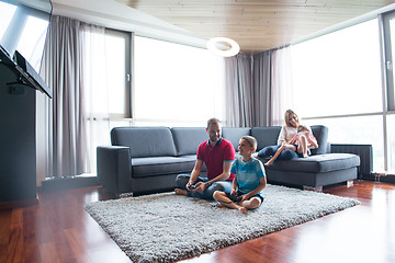 Image showing Happy family playing a video game