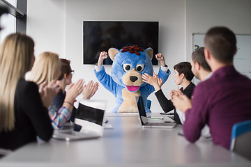 Image showing boss dresed as bear having fun with business people in trendy of