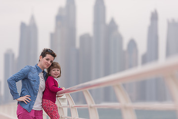 Image showing mother and cute little girl on the promenade