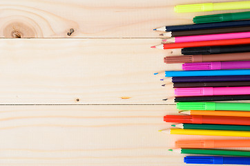 Image showing Colored pencils on a wooden board