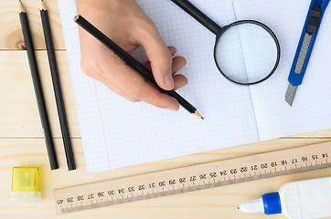 Image showing Draftsman workplace equipped with ruler, pen, stapler, scissors, magnifying glass.