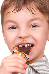 Image showing Little boy eating chocolate